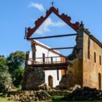 Ruínas de pedra com estrutura metálica e passarela de visitação no Sítio Histórico de Queimado, na Serra.